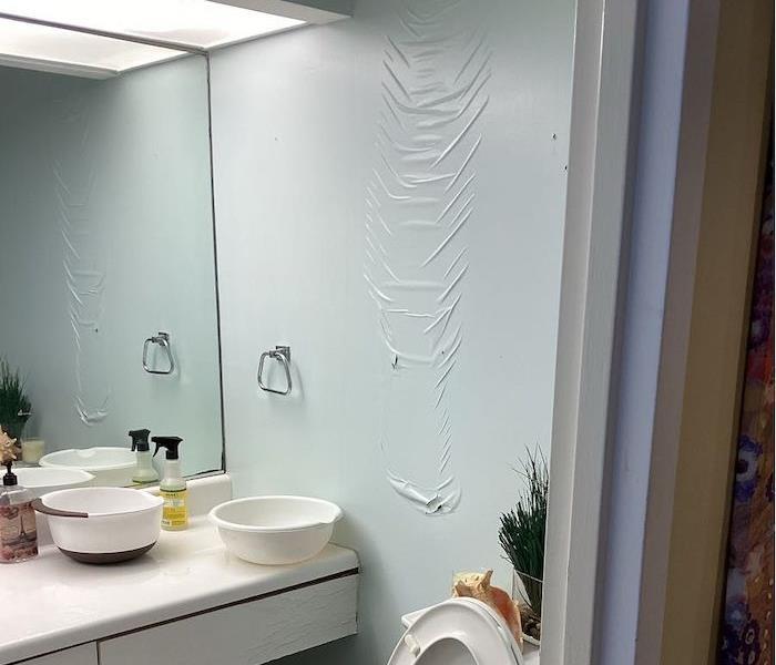 A bathroom with severe water damage.